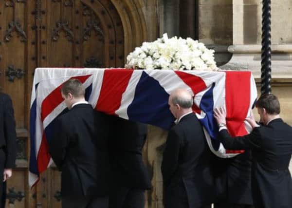 Margaret Thatcher is carried from a hearse as it arrives at the Houses of Parliament to rest overnight. Picture: AP