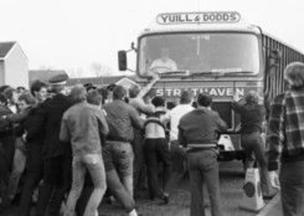 Members of the NUM miners' union picket line try to stop lorries delivering coal to Ravenscraig steelworks in May 1984. Picture: TSPL