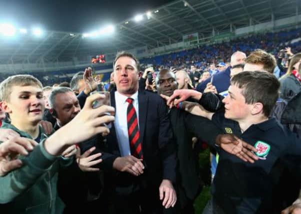 Cardiff City Manager Malky Mackay is mobbed by fans after his team's promotion to the Premier League. Picture: Getty