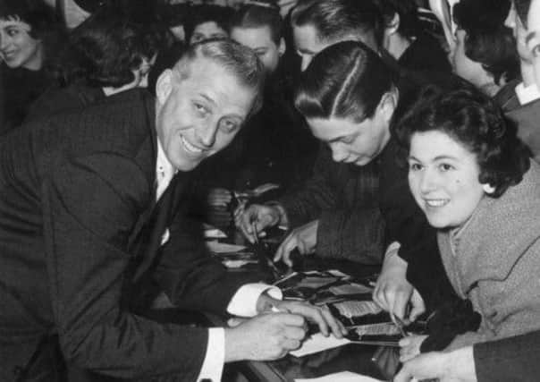 American jazz band leader Stan Kenton signing autographs while on a visit to London in 1956. Picture: Getty