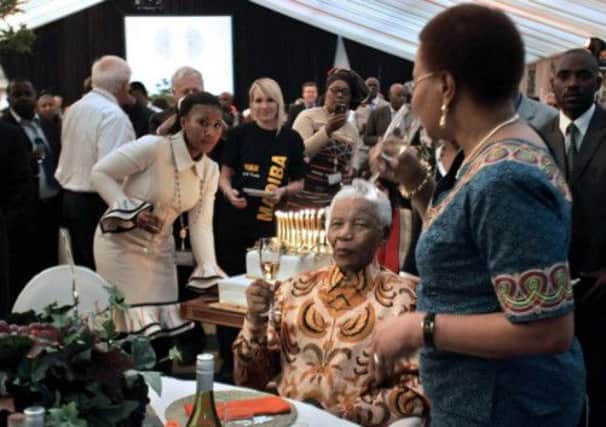 Nelson Mandela, pictured with his wife Graca Machel and granddaughter Tukwini Mandela. Picture: Getty/AFP