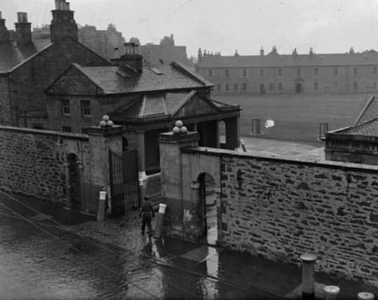 A picture from 1951 shows the original military barracks and surrounding wall