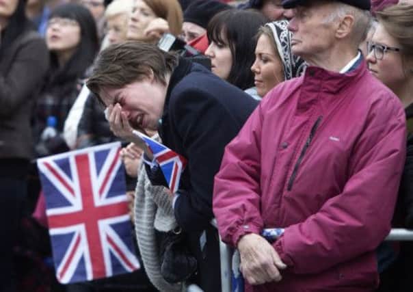 A member of the public weeps as the coffin of Baroness Thatcher passes. Picture: Getty
