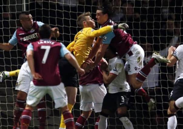 Andy Carroll and David de Gea collide in the Manchester United goalmouth. Picture: Reuters