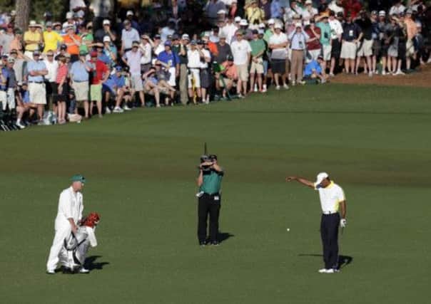 Woods drops his ball in the wrong place  a move he later said he deliberately made to gain a better shot at the green. Picture: AP
