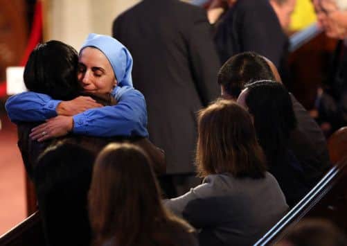 A nun hugs a woman at the service. Picture: Getty