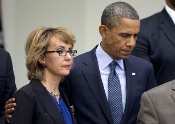 President Barack Obama comforts former Representative Gabrielle Giffords. Picture: AP