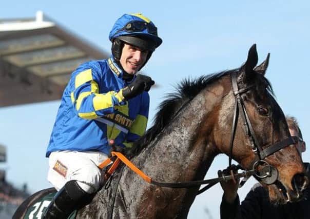 Ryan Mania celebrates his Grand National win. He will be back in the saddle for the Scottish National. Picture: PA