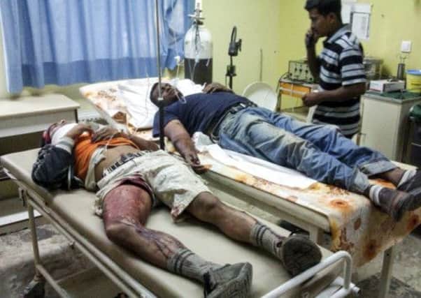 Bangladeshi workers receive first aid near the southwestern Greek town of Manolada. Picture: Reuters