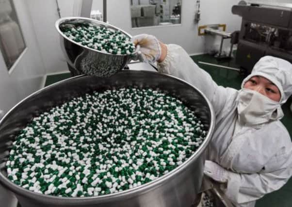 Employees work on the production of Shufeng Jiedu Capsule, a Herbal Medicine for treating avian influenza. Picture: Getty