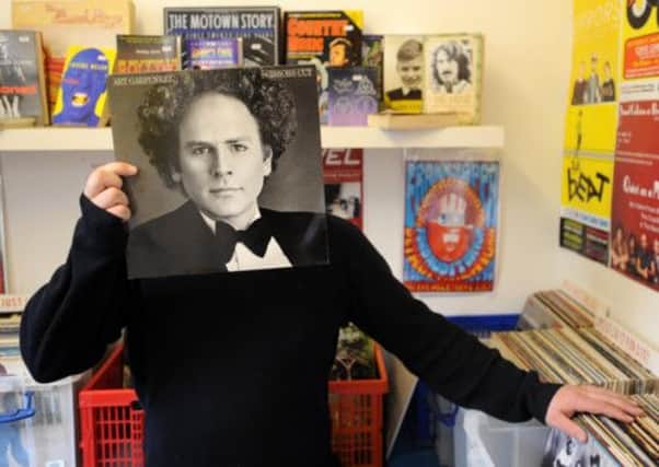 Darren Yeats, co-owner of Voxbox, with an Art Garfunkel album. Picture: Jane Barlow