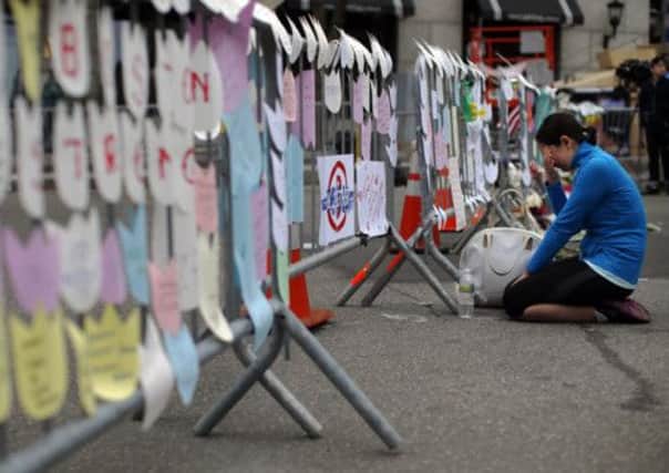 A mourner kneels at a memorial for the victims of the Boston Marathon bombings. Picture: Reuters
