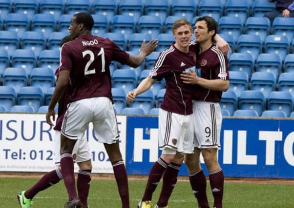 Hearts ace John Sutton celebrates his opener with team-mates. Picture: SNS