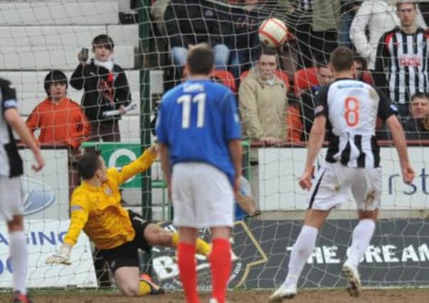 Stephen Husband scores from the penalty spot to help Dunfermline in their relegation battle. Picture: Joey Kelly