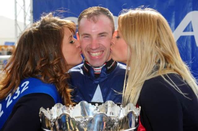 Wayne Hutchinson is all smiles as he poses after winning the Coral Scottish Grand National. Picture: Robert Perry