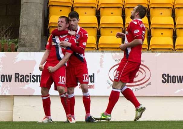 Richard Brittain (left) celebrates his second equaliser with team-mate Rocco Quinn. Picture: SNS