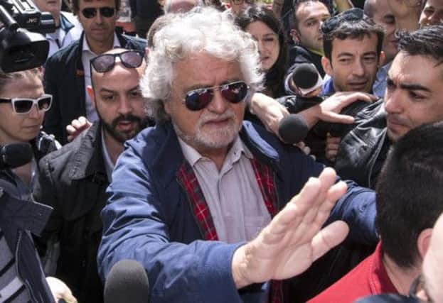 Beppe Grillo arrives at a press conference yesterday, where he denounced the reelection of Giorgio Napolitano. Picture: AP