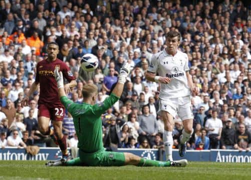 Tottenham Hotspur's Welsh midfielder Gareth Bale (R) scores their third goal past Manchester City's English goalkeeper Joe Hart (2nd L) during the English Premier League football match between Tottenham Hotspur and Manchester City at White Hart Lane in north London on April 21, 2013. AFP PHOTO / IAN KINGTONRESTRICTED TO EDITORIAL USE. No use with unauthorized audio, video, data, fixture lists, club/league logos or âliveâ services. Online in-match use limited to 45 images, no video emulation. No use in betting, games or single club/league/player publicationsIAN KINGTON/AFP/Getty Images