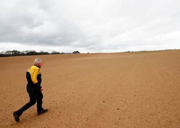 Farmer Cameron MacIver, from Forres in Moray,  on one of his sand covered barley fields.  Picture: Hemedia