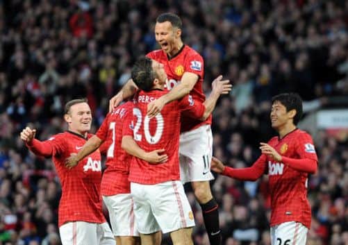 Manchester United's Robin van Persie celebrates with his team-mate Ryan Giggs after scoring his team's opening goal. Picture: PA