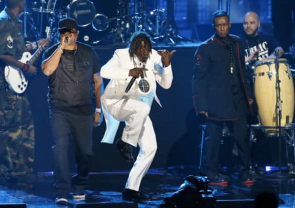 Chuck D, left, Flavor Flav, center, and Professor Griff, standing right, of Public Enemy perform during the Rock and Roll Hall of Fame Induction Ceremony in LA.  Picture: AP