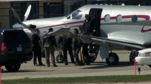 Chiheb Esseghaier was met by police on landing in Ontario. Picture: Reuters