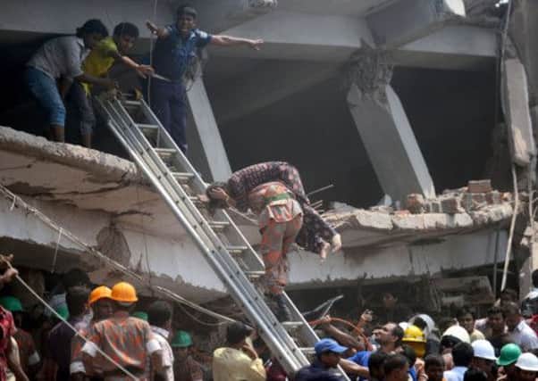 A Bangladeshi firefighter carries an injured garment worker. Picture: Getty Images