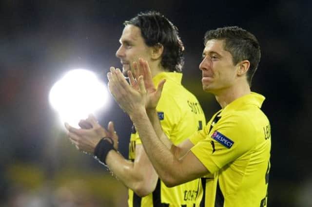 Dortmunds Robert Lewandowski, right, and Neven Subotic hail their fans. Picture: Odd Andersen/AFP/Getty