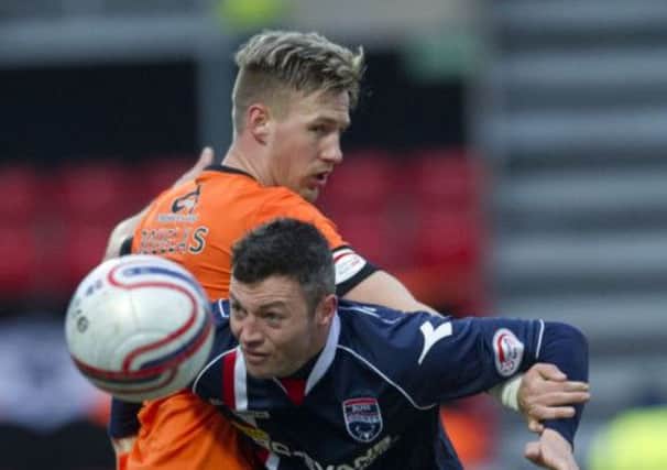 Ivan Sproule tries to get past Dundee United's Barry Douglas, who was later sent off for a challenge on the Ross County winger. Picture: SNS