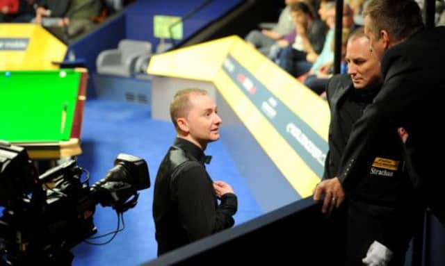 Graeme Dott complains to officials after receiving electric shocks from the table in his match against Shaun Murphy in Sheffield. Picture: PA