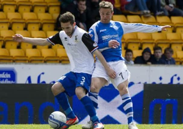 Graeme Shinnie, left, is closed down by St Johnstone's Chris Millar. Picture: SNS