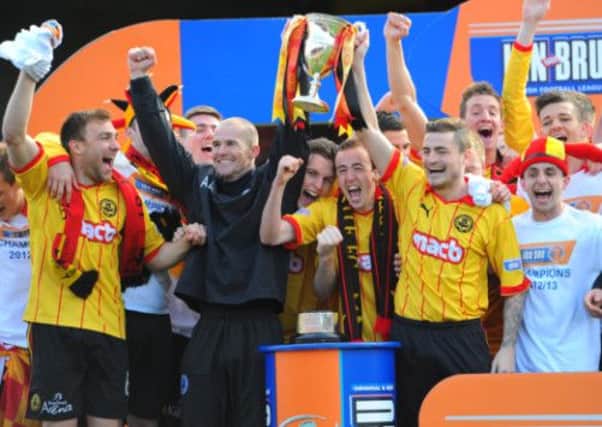 Partick Thistle celebrating with the First Division trophy. Picture: Robert Perry