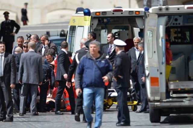 A policeman receives assistance after being shot in Rome. Picture: Getty