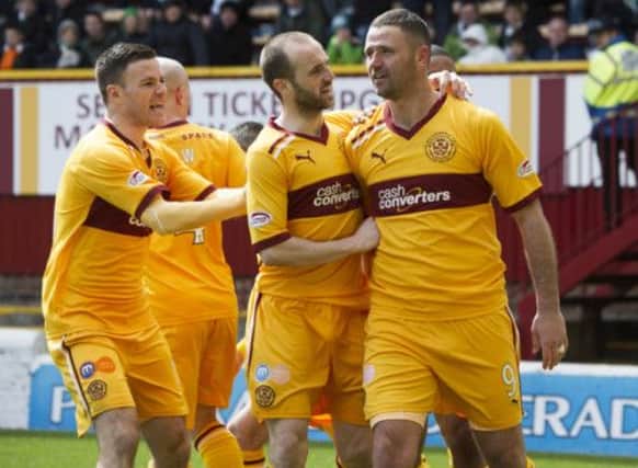 Motherwell striker Michael Higdon is hailed by his team-mates after making it 2-1. Picture: SNS