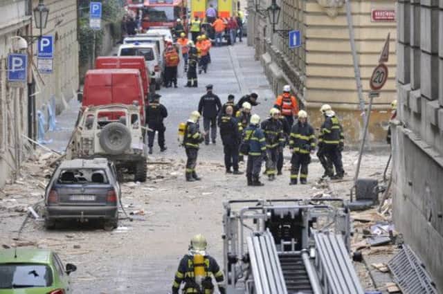 Firefighters and rescue workers work at the scene of the blast in a building in the center of Prague. Picture: AP