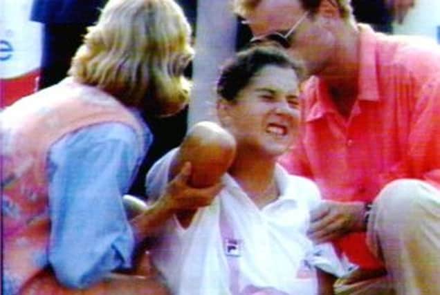 Monica Seles is attended to by medics after being stabbed during a tournament in Germany on this day in 1993. Picture: Getty
