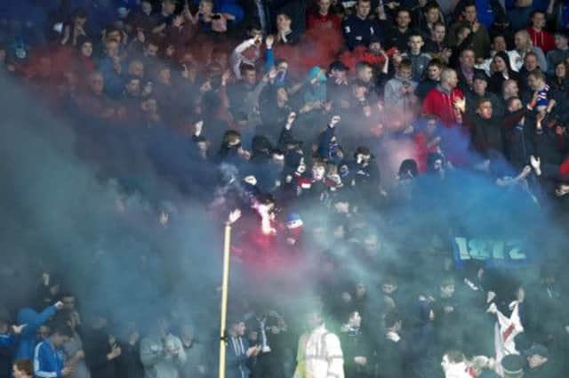 Fans let off flares during the under-17s cup final between Rangers and Celtic at Firhill Stadium. Picture: SNS