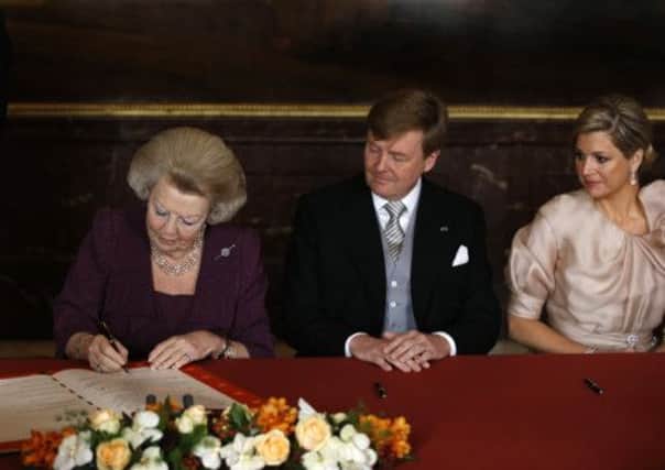 Queen Beatrix of the Netherlands signs the Act of Abdication. Picture: Getty