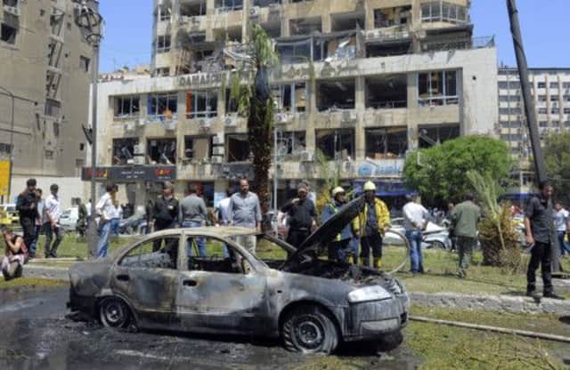 A burnt-out car at the scene of the bombing. Picture: AP