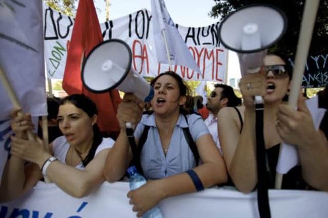 Protesters gathered outside parliament in Nicosia yesterday. Picture: AP
