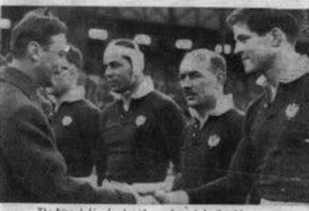 King George VI shakes hands with Bill Young, right, at Twickenham. Picture: Complimentary
