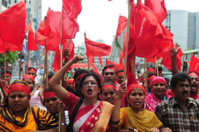 Angry Bangladeshi activist workers shout slogans and wave flags during a procession to mark May Day in Dhaka.   Picture: Getty