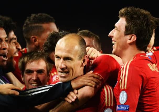 Arjen Robben is mobbed by his Bayern Munich team-mates after opening the scoring. Picture: Getty