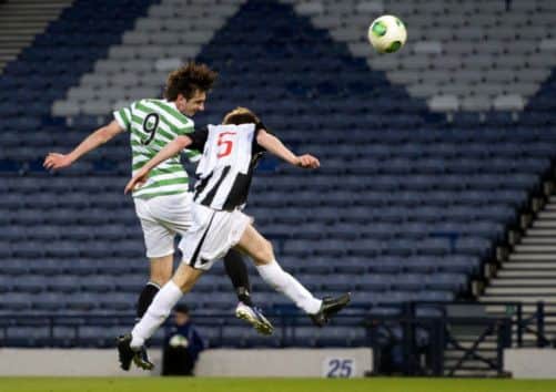 Celtic's Bahrudin Atajic beats Dunfermlines Lewis Martin in the air to give Celtic a 2-0 cushion at Hampden last night. Picture: SNS