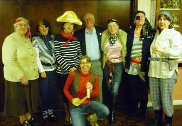 The ladies of Parkham WI in fancy dress with Captain Colin Darch