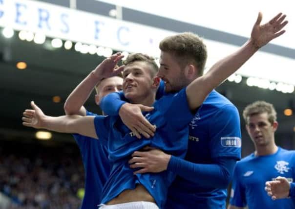 Kyle Hutton hails Rangers team-mate Fraser Aird after opening the score. Picture: SNS