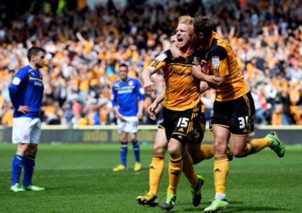 Hull goalscorer Paul McShane is congratulated by teammate David Meyler after he scored the goal that promotes them. Picture: Getty