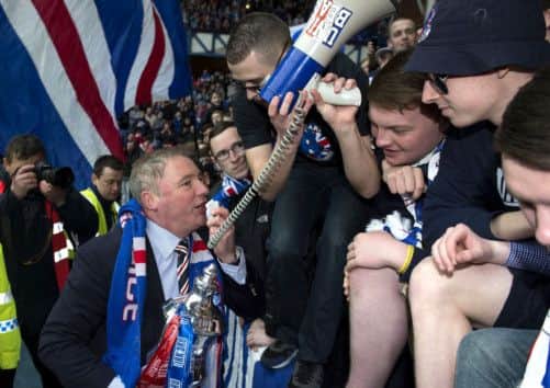 Rangers manager Ally McCoist celebrates the club's title win with supporters. Picture: SNS