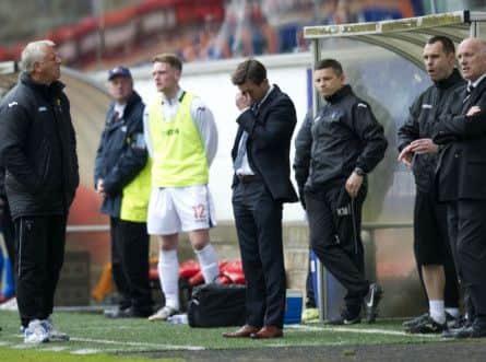 Jim Jefferies and the Pars bench look worried as news of Cowdenbeath's win arrives. Picture: SNS
