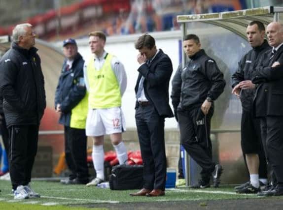 Jim Jefferies and the Pars bench look worried as news of Cowdenbeath's win arrives. Picture: SNS